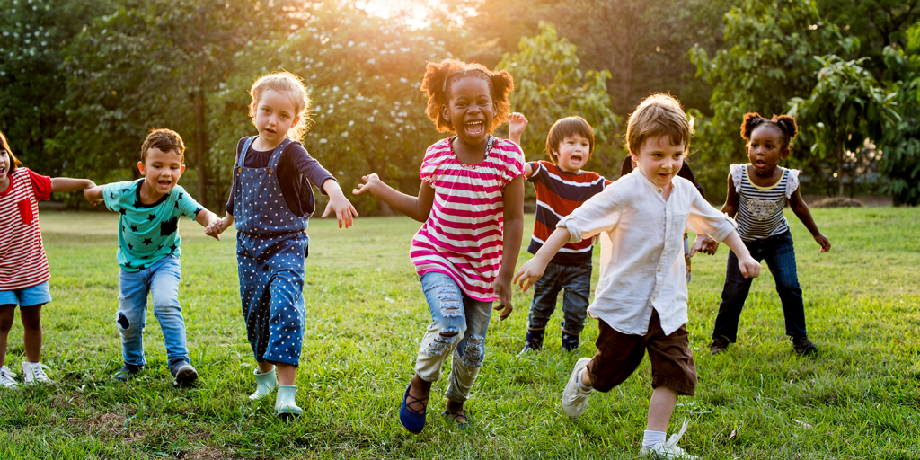 group-of-diverse-kids-playing-at-the-field-together